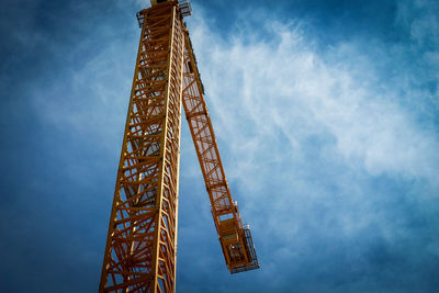 Low angle view of crane against sky