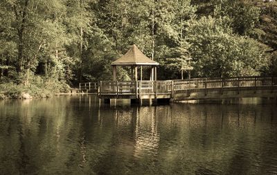 Built structure by lake against sky