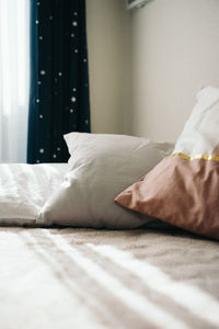 Low section of man relaxing on bed at home