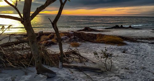 Scenic view of beach against sky during sunset