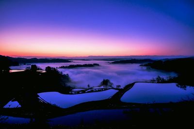 Scenic view of silhouette landscape against sky at sunset