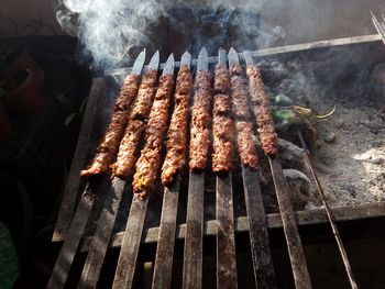 High angle view of meat on barbecue grill