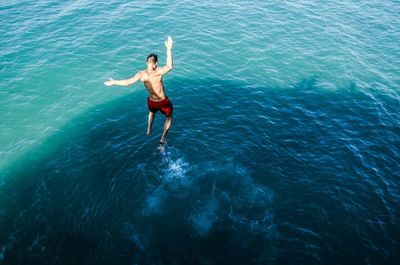 Woman jumping in sea