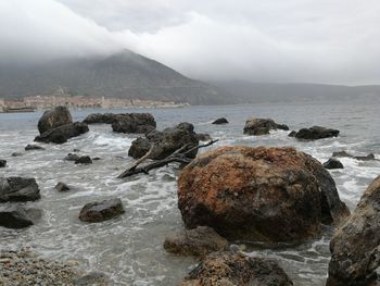 Rocks on beach against sky