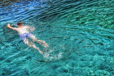 High angle view of man swimming in pool