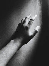 Cropped hand of person on wall