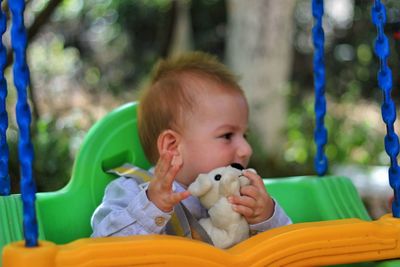 Portrait of cute girl sitting outdoors