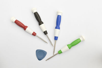 High angle view of colored pencils on white background