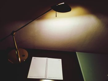 Close-up of electric lamp on table at home