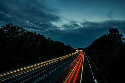 High angle view of light trails on highway at night