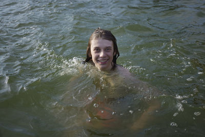Teenage boy swimming in water