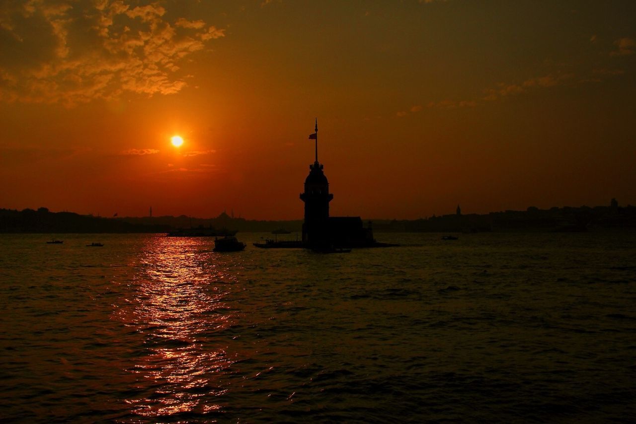 sunset, water, waterfront, orange color, sun, silhouette, scenics, sea, sky, built structure, architecture, building exterior, tranquil scene, rippled, tranquility, beauty in nature, nature, idyllic, reflection, river