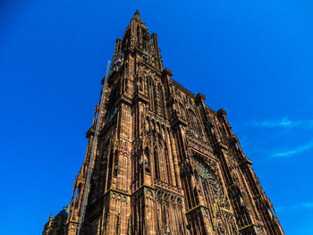 Low angle view of strasbourg cathedral against blue sky