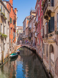 Bridge over canal amidst buildings in venice, italy