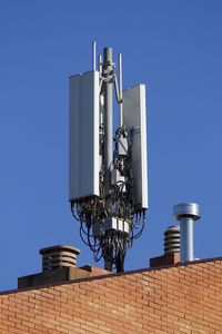 Low angle view of telephone pole against sky