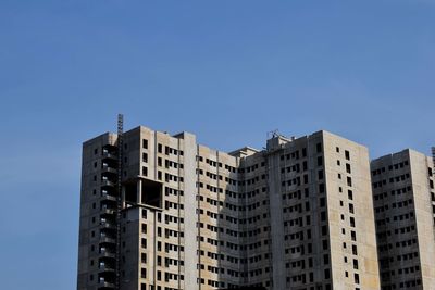 Low angle view of buildings against blue sky