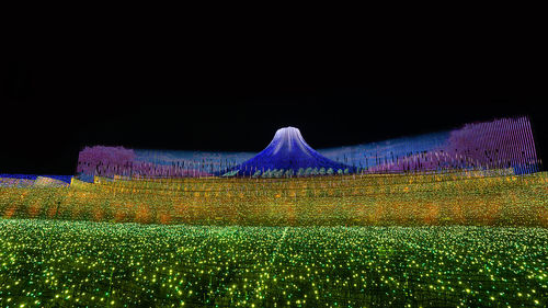 Light painting on field against sky at night