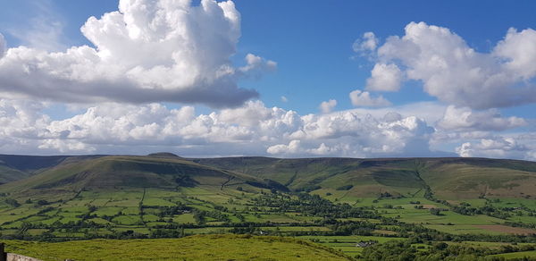 Panoramic view of agricultural field against sky