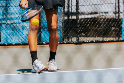 Low section of girl playing tennis