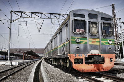 Train at railroad station against sky