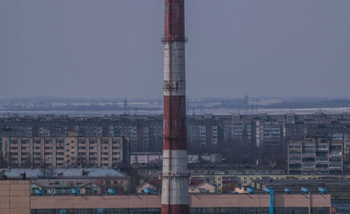 Tower amidst buildings against clear sky