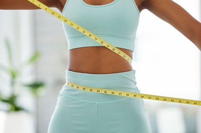 Midsection of woman standing against sky