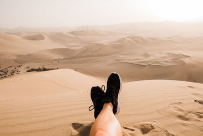 Man standing on sand dunes in desert
