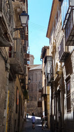 Street amidst buildings in city against sky