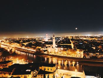 High angle view of illuminated buildings in city at night