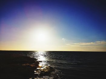Scenic view of sea against sky at sunset