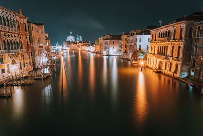 Grand canal amidst illuminated buildings in city at night