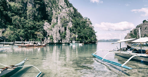 Boats sailing in sea against sky