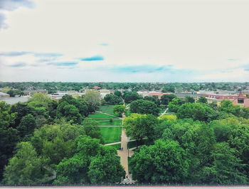 Buildings in city against cloudy sky