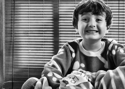 Portrait of cute boy smiling at home