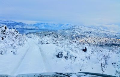 Scenic view of snowcapped mountains against blue sky