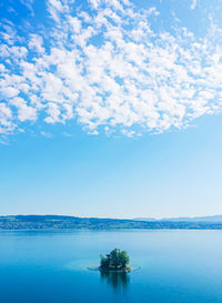 Scenic view of sea against blue sky