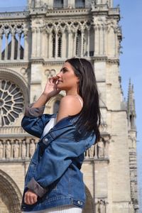 Young woman standing at historical building