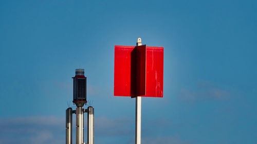 Low angle view of fire against blue sky