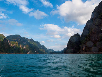 Scenic view of sea and mountains against sky