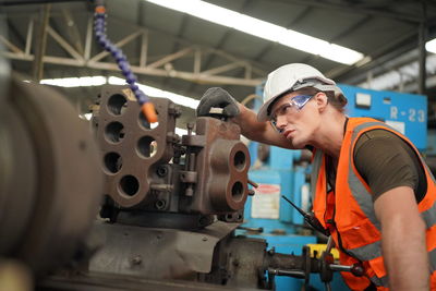 Portrait of male worker standing in the heavy industry manufacturing factory.