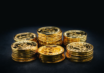 Close-up of coins on table against black background