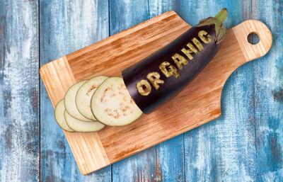 Close-up of eggplant on wooden chopping board