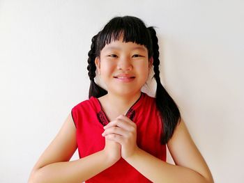 Portrait of smiling woman against white background