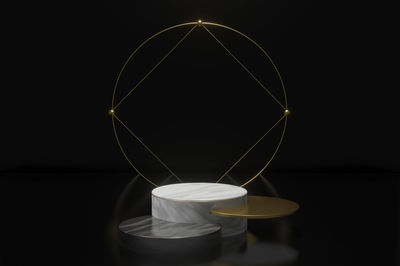 Close-up of illuminated lamp on table against black background
