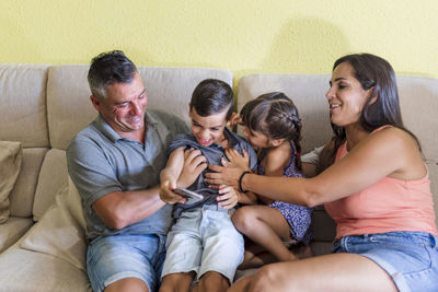 Family with children having fun at home