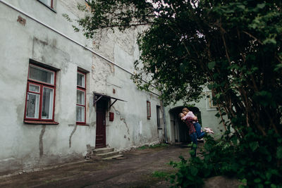 Woman standing by building