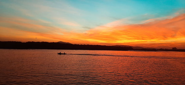 Scenic view of sea against orange sky