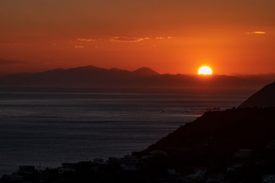 Scenic view of sea against romantic sky at sunset