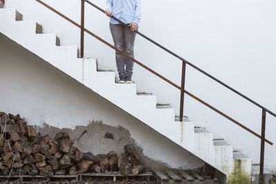 Low section of man standing on staircase