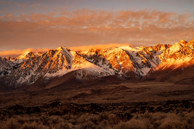 Scenic view of snowcapped mountains against sky during sunset